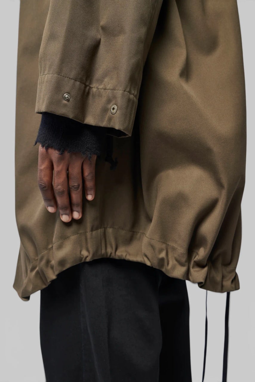 The parka’s drawstring hem gathered at the hip.