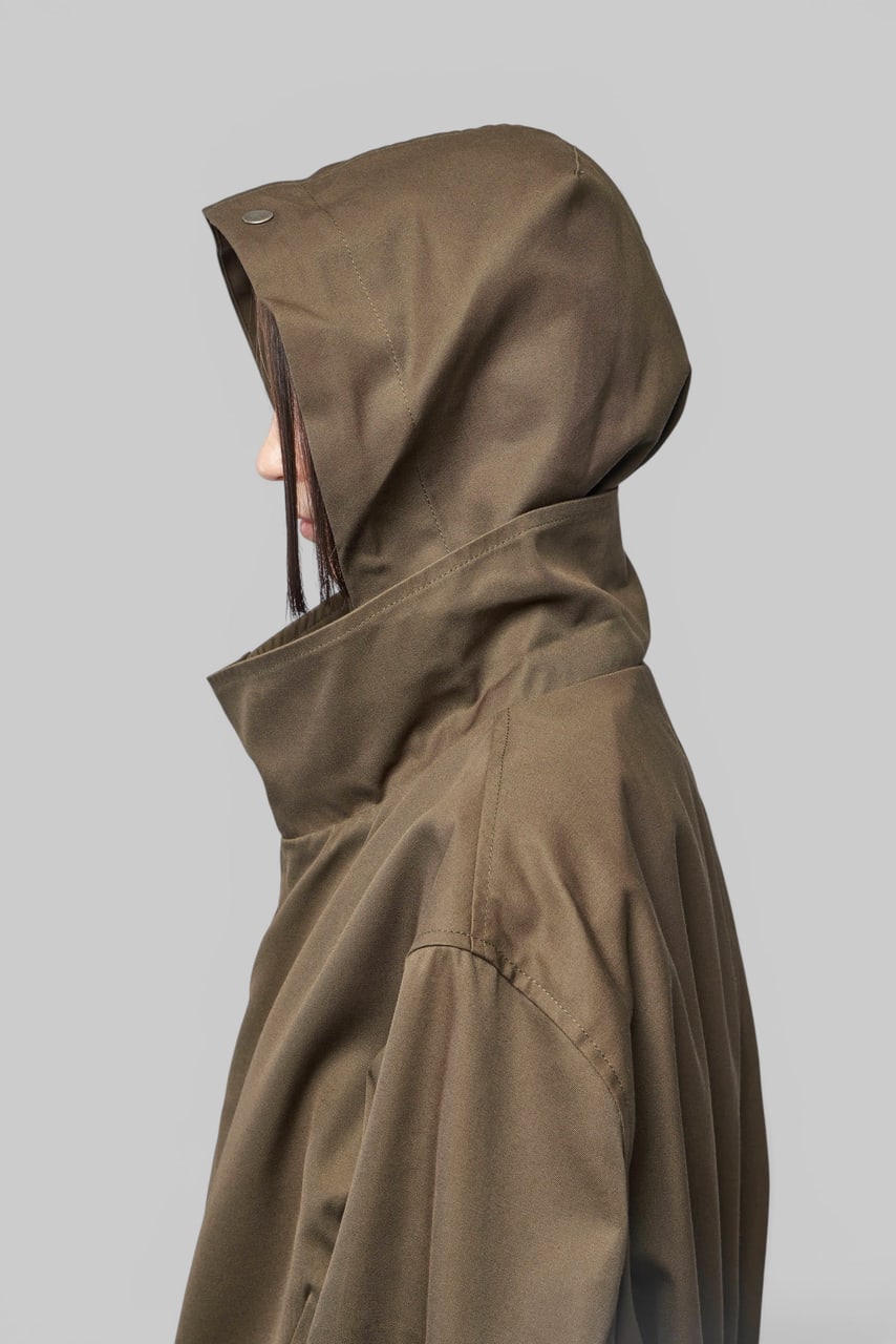The parka’s hood in profile, in olive cotton.