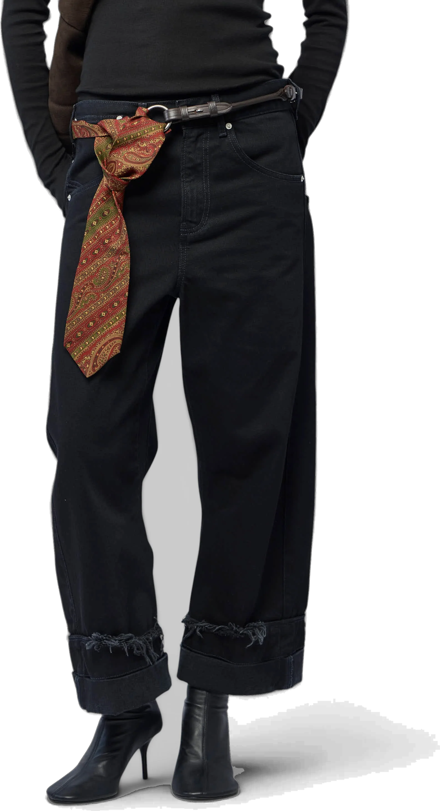 The Wide-Leg Jeans in black, frayed turn-ups at the hem and a patterned silk scarf knotted through the belt.